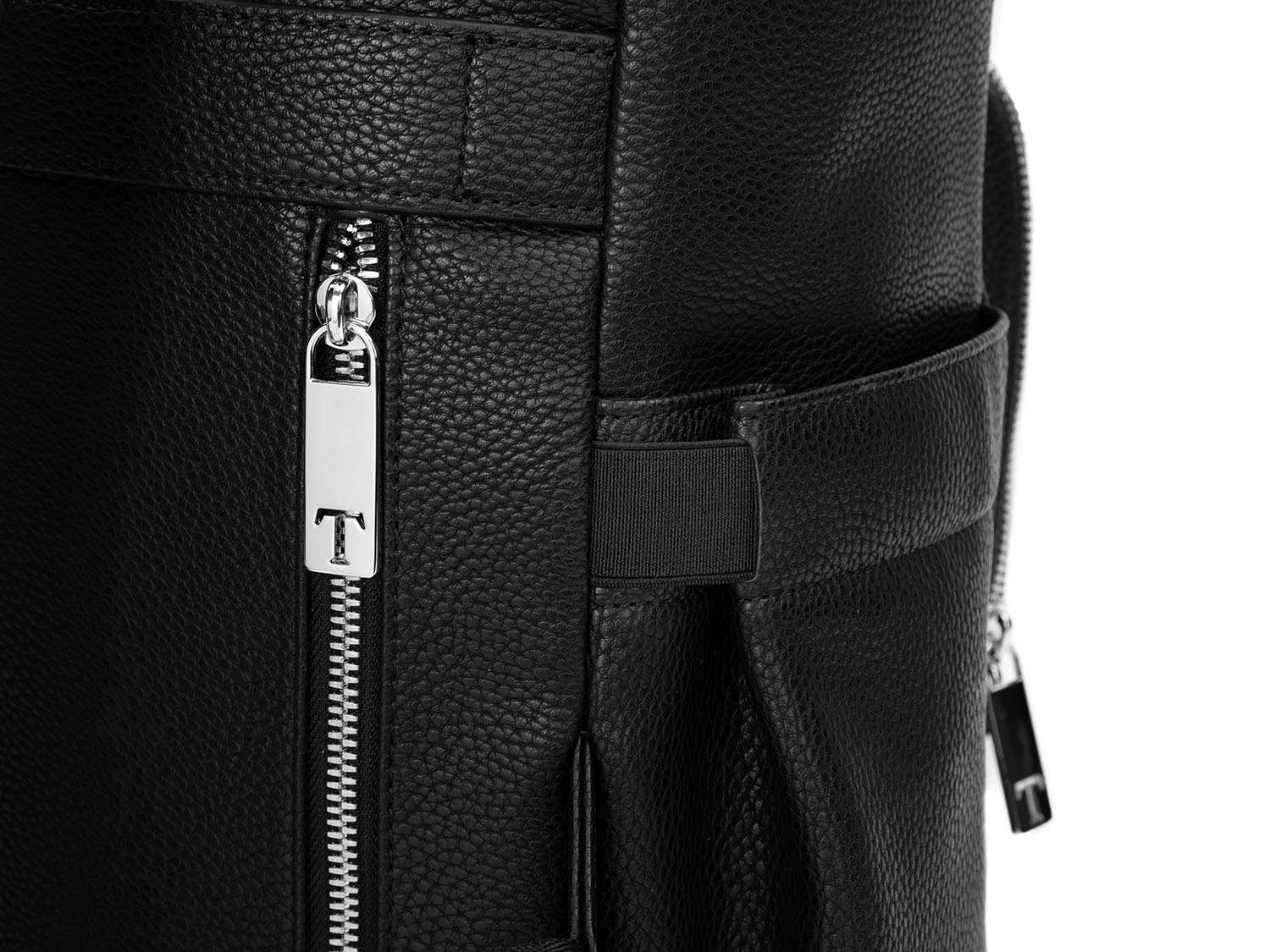 A black leather baby backpack with silver zippers on white background