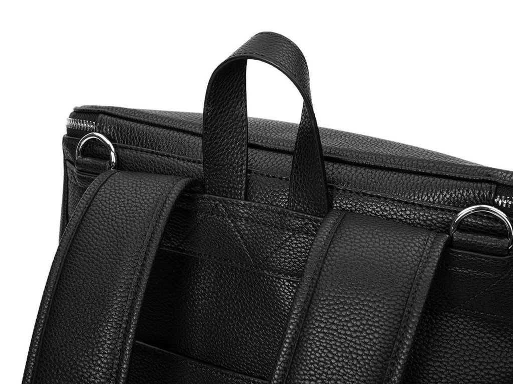 A black leather baby backpack with silver zippers on white background